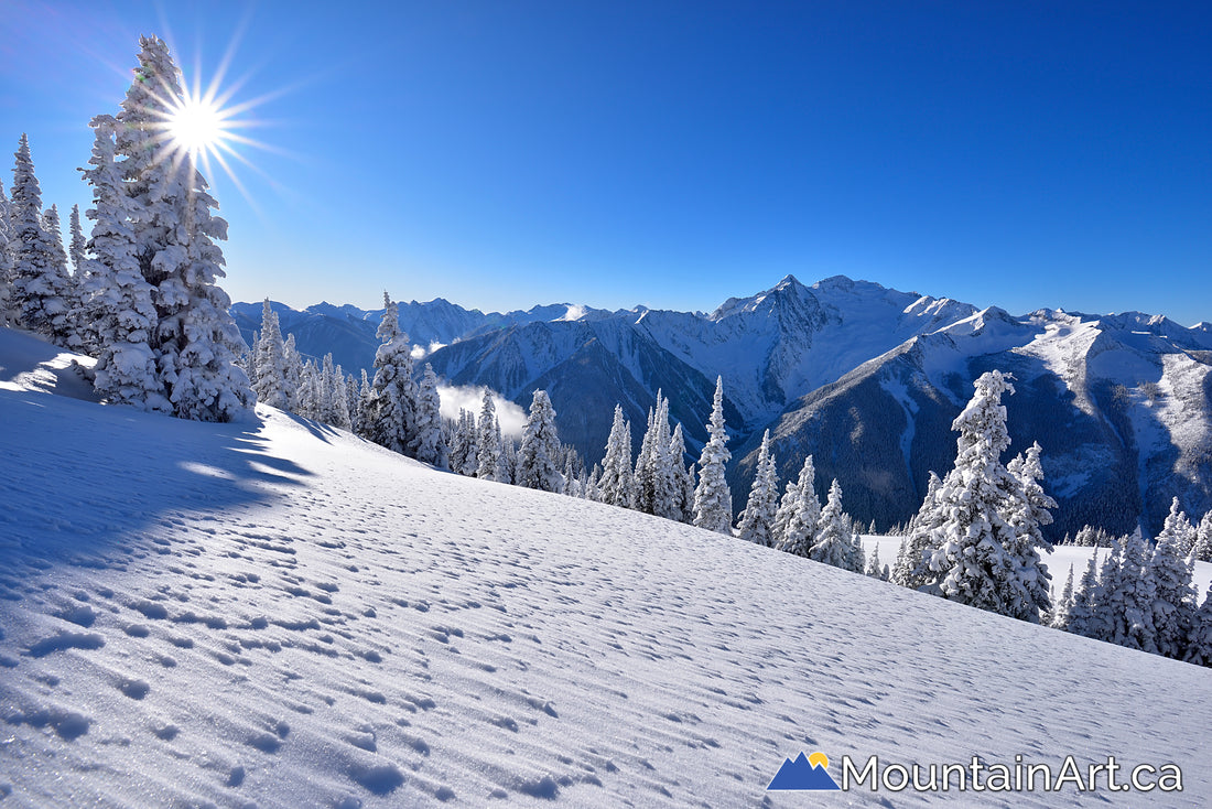 meadow mountain winter scene with mt cooper and a sunstar