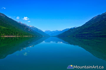 Upper Duncan Lake with Badshot mountains reflecting in glacial watersbc canada