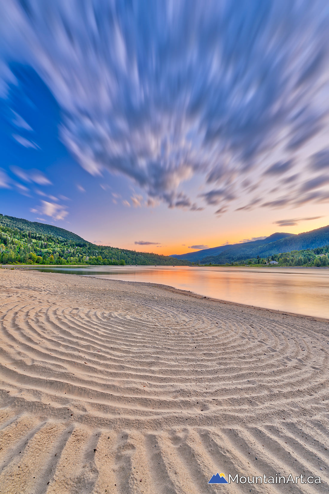 colorful sunset with sand swirl and sweeping clouds taghum beach nelson bc