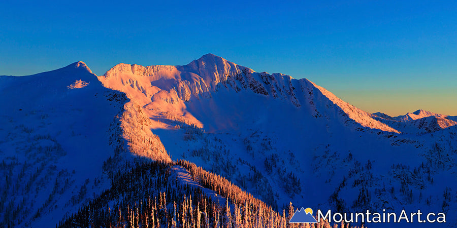 alpenglow sunset on Ymir Peak and Ymir Bowl panorama whitewater Nelson bc